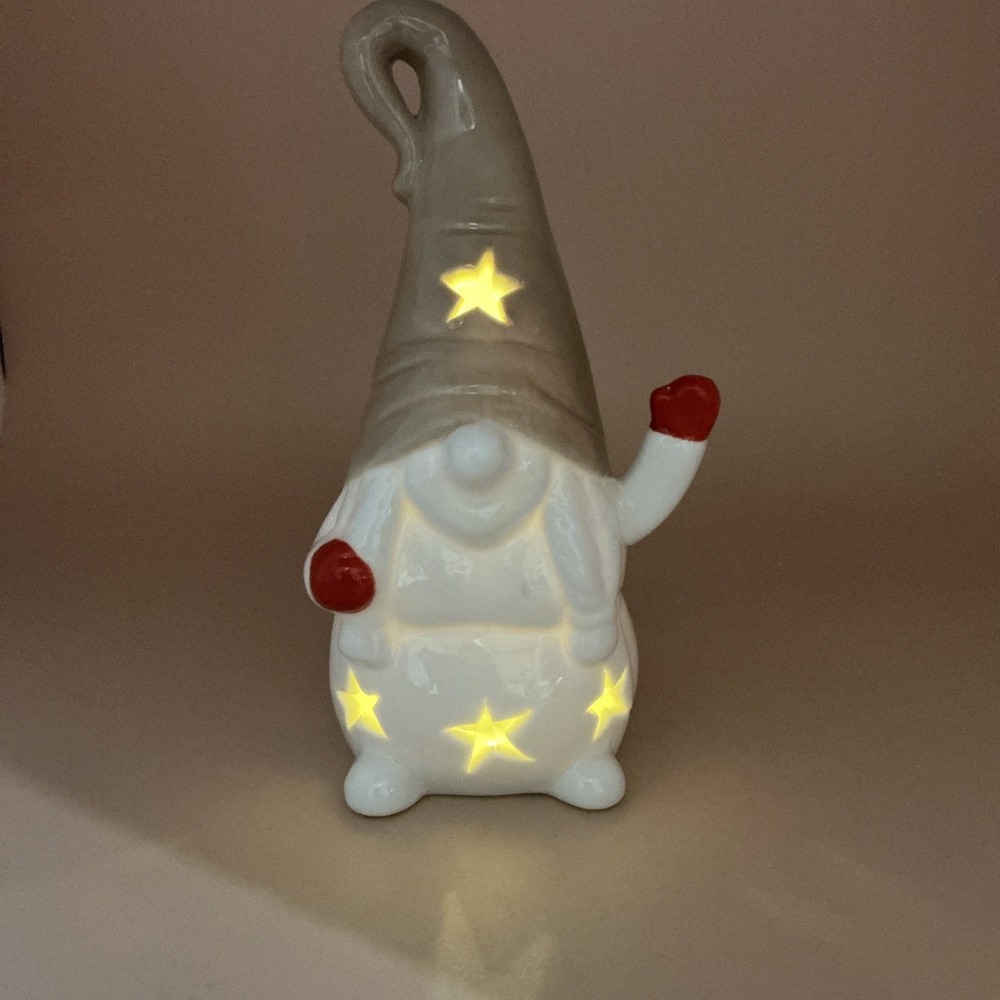 Little Glossy Ceramic Holiday Gnome with Battery Lights &‎ Star Shaped Cutouts.
